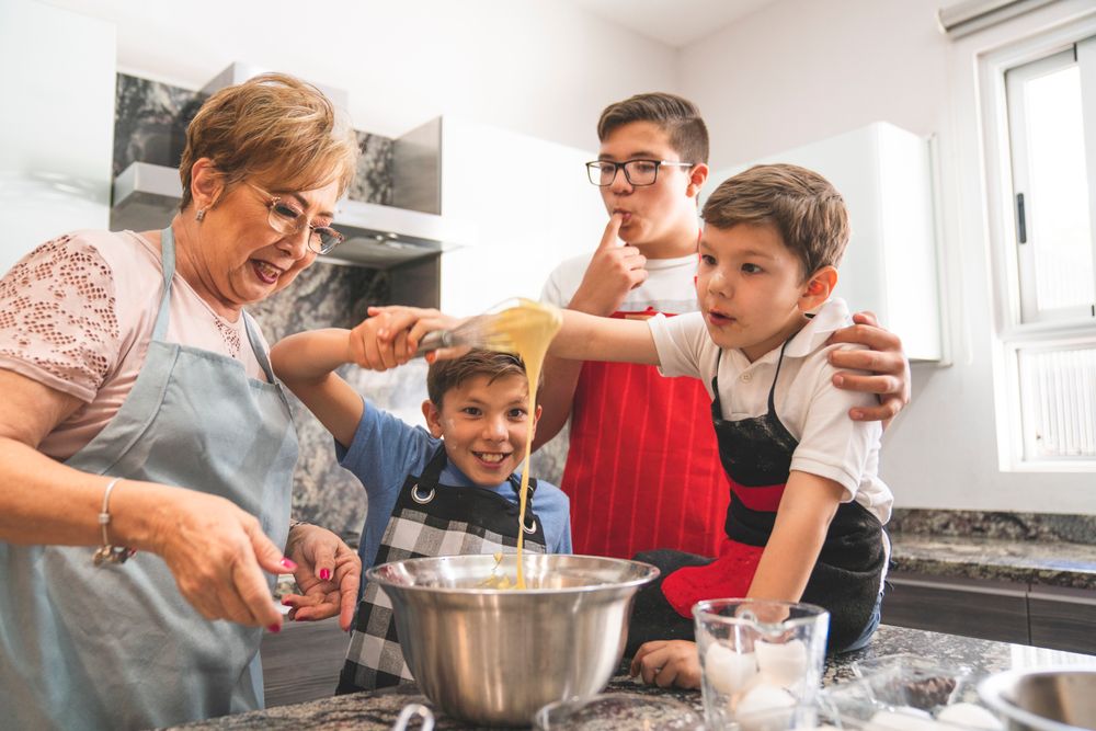 A grandmother baking in the kitchen with her grandsons