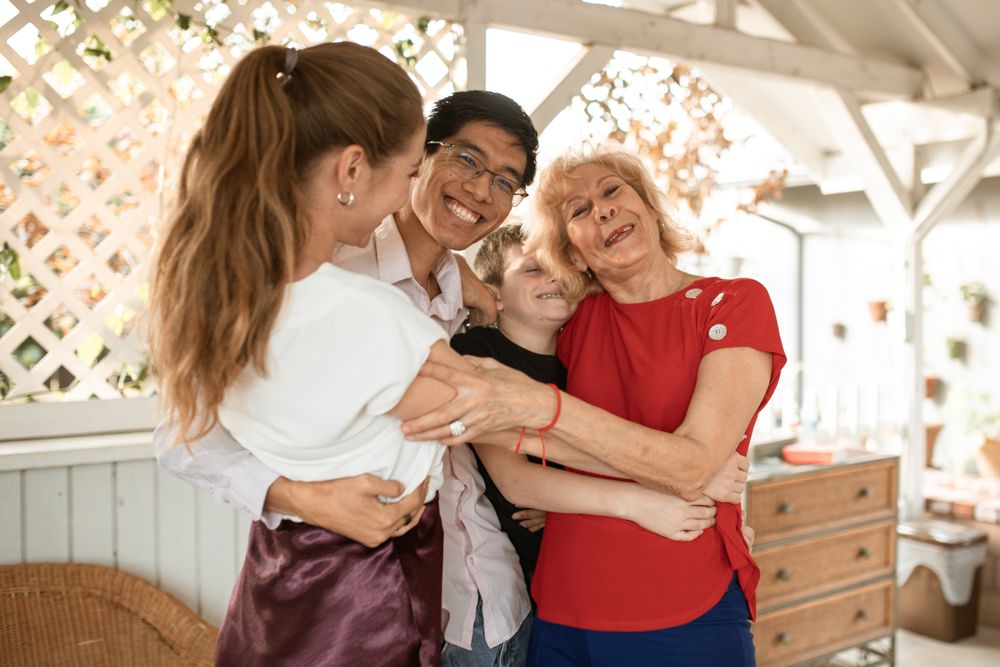 A multigenerational family sharing a warm group hug