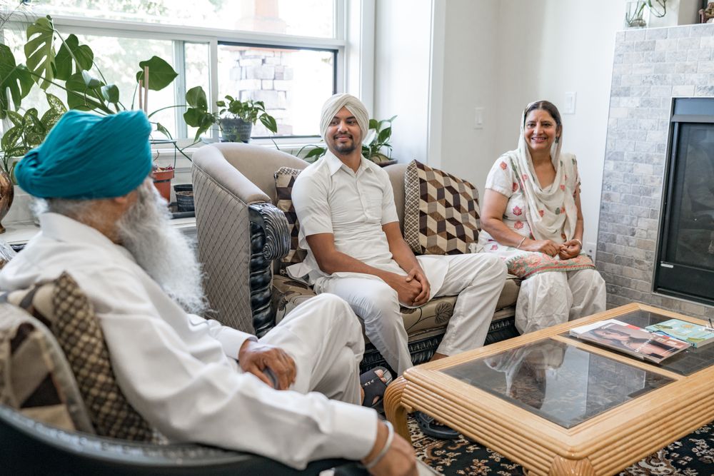 A family of three together in the living room of their home